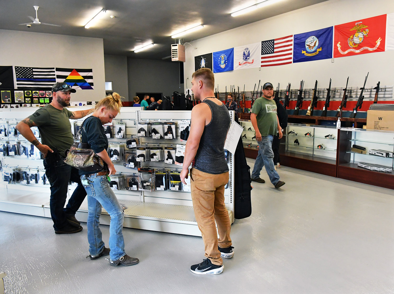 Customers browse the merchandise inside Long Shot Inc. in Yelm on Thursday, Aug. 6.