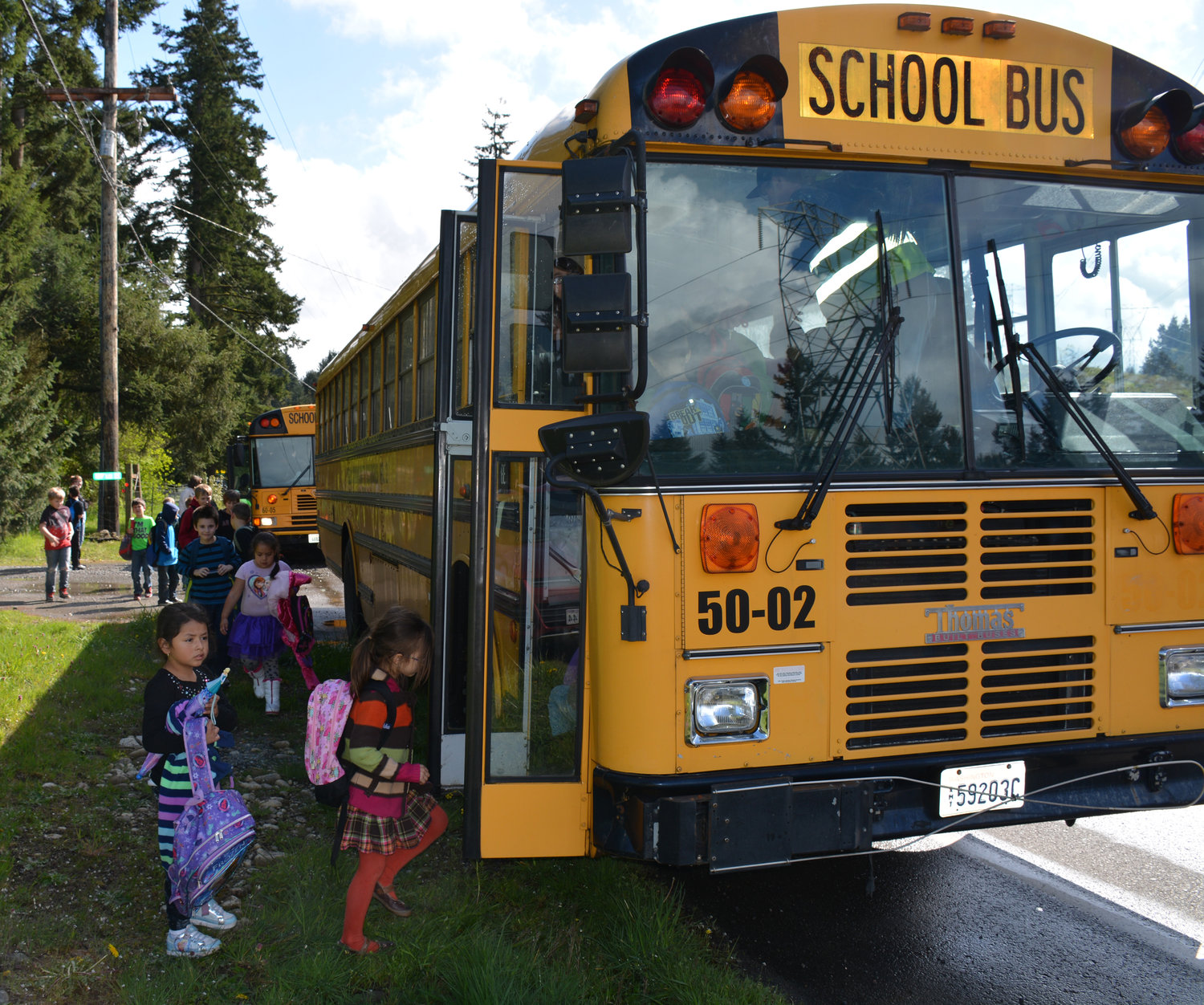 Students enter a bus in this file photo.