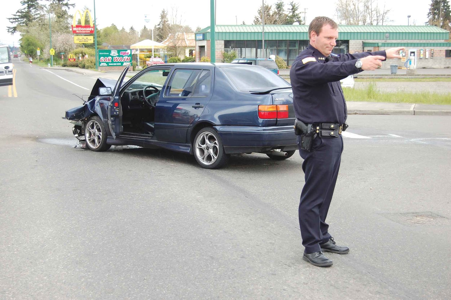 Yelm Police Chief Todd Stancil directs traffic off Yelm Avenue around a two-car accident in this file photo.
