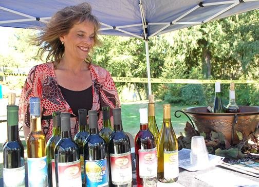 Tenino’s Scatter Creek Winery co-owner Andrea Keary offers some of her award-winning wines in this file photo.