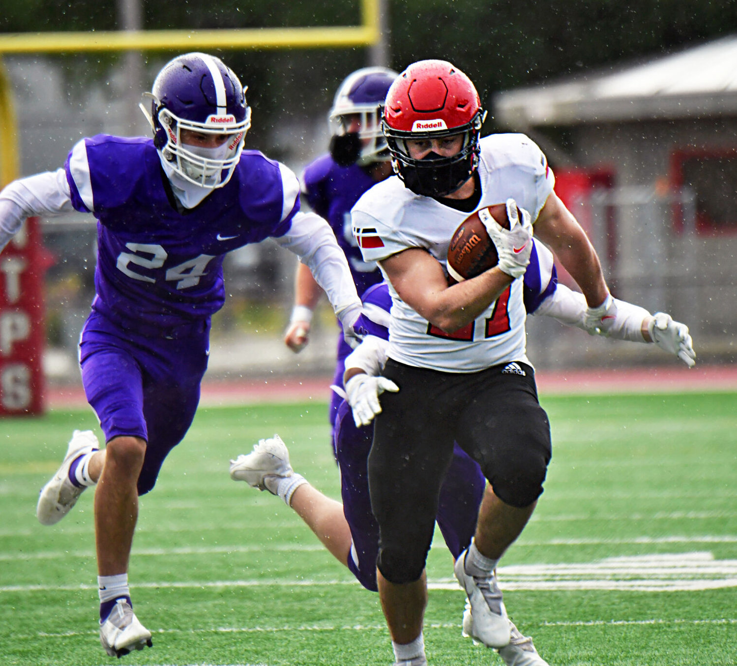 Yelm High School running back Sean Rohwedder ecludes North Thurston High School defenders as he gains good yardage on Friday, March 19, at South Sound Stadium.