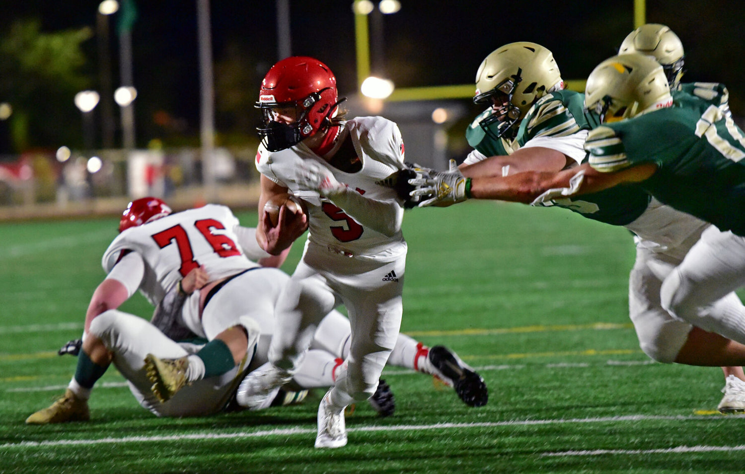With a huge assist from teammate Dylan Jemtegaard, 76, Yelm High School’s Kyler Ronquillo scores a touchdown on Friday, March 12, against Timberline High School at South Sound Stadium.