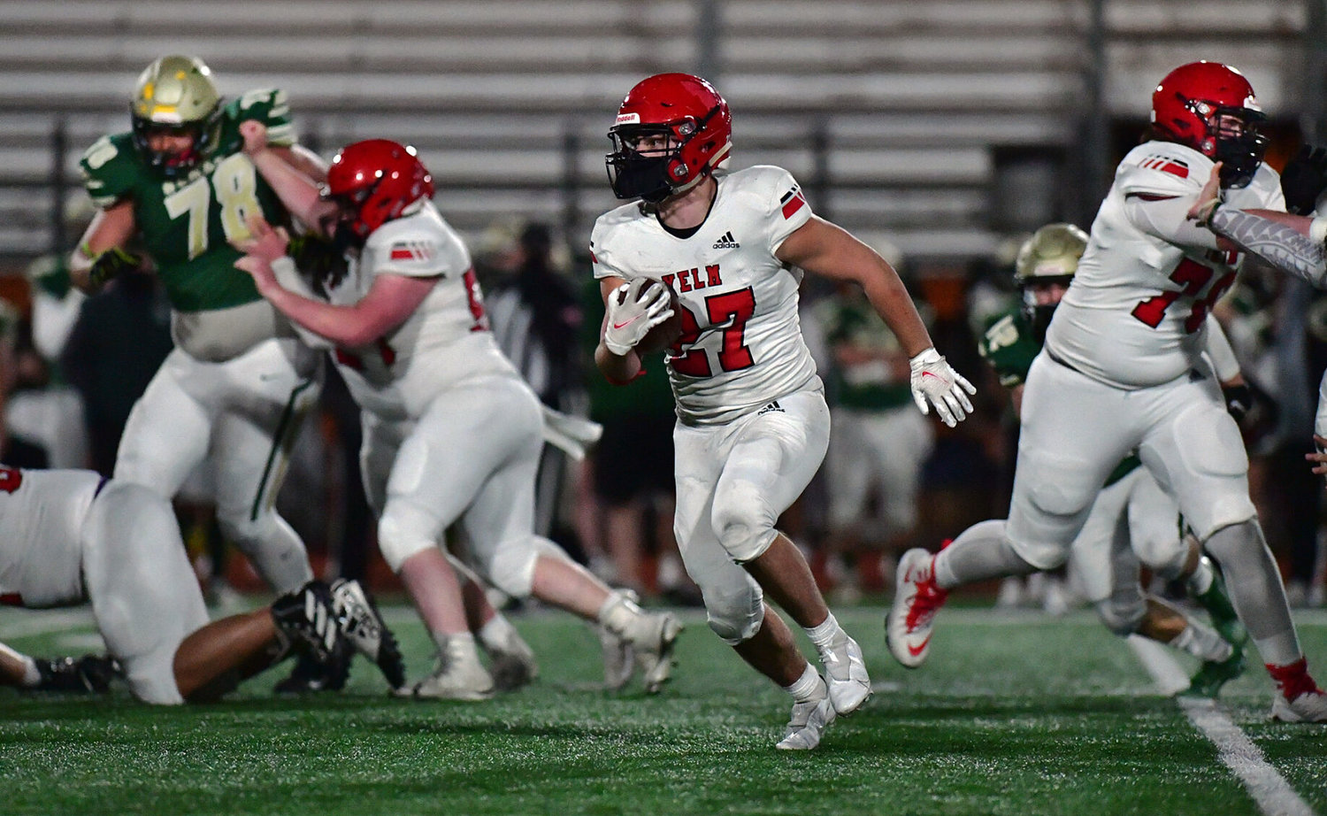 With the help of some nifty blocking, Yelm High School running back Sean Rohwedder rips off a big gain on Friday, March 12, against Timberline High School at South Sound Stadium.