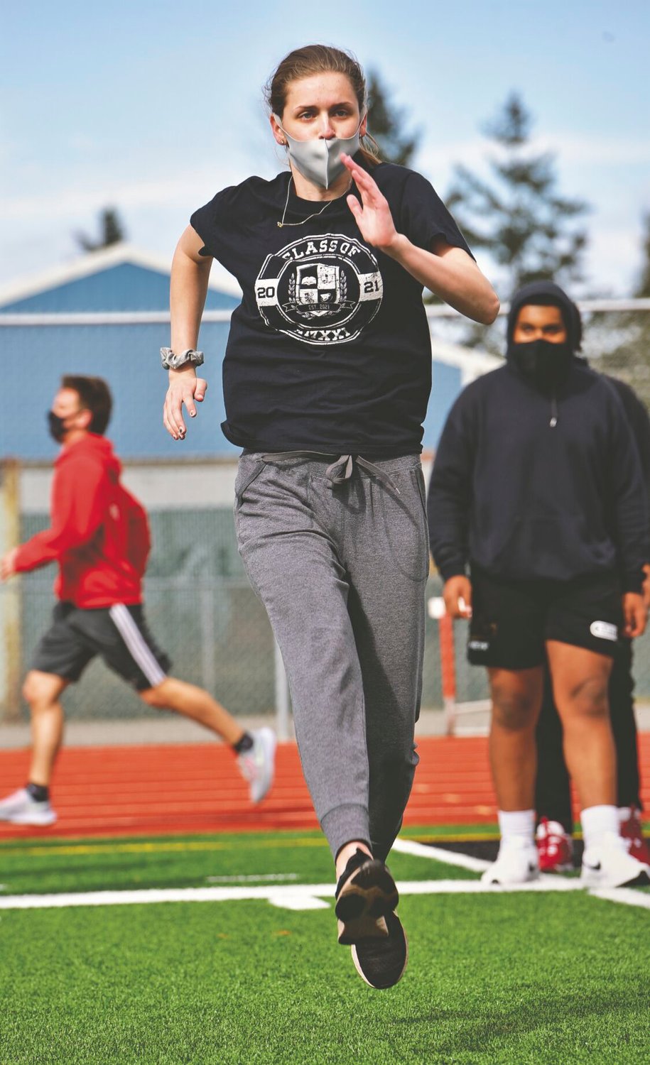Yelm High School high jumper Abigail Carlson goes through warmups with her track and field teammates on Monday, March 22.