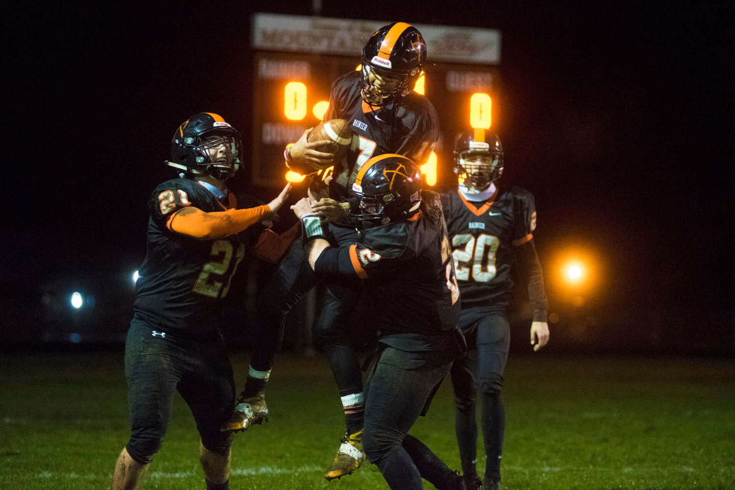 Rainier's Jacob Uch gets lifted up by teammates after catching a 40-yard touchdown pass against Adna on Friday.
