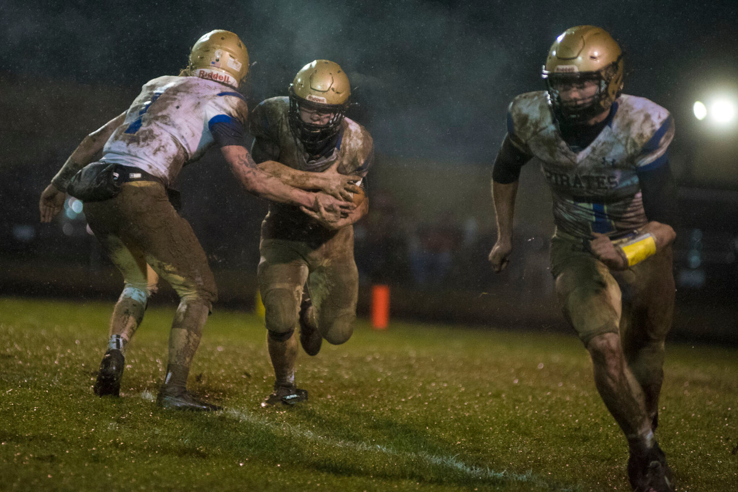 Adna quarterback Ryan Young (1) hands off to a Pirate rusher against Rainier Friday.