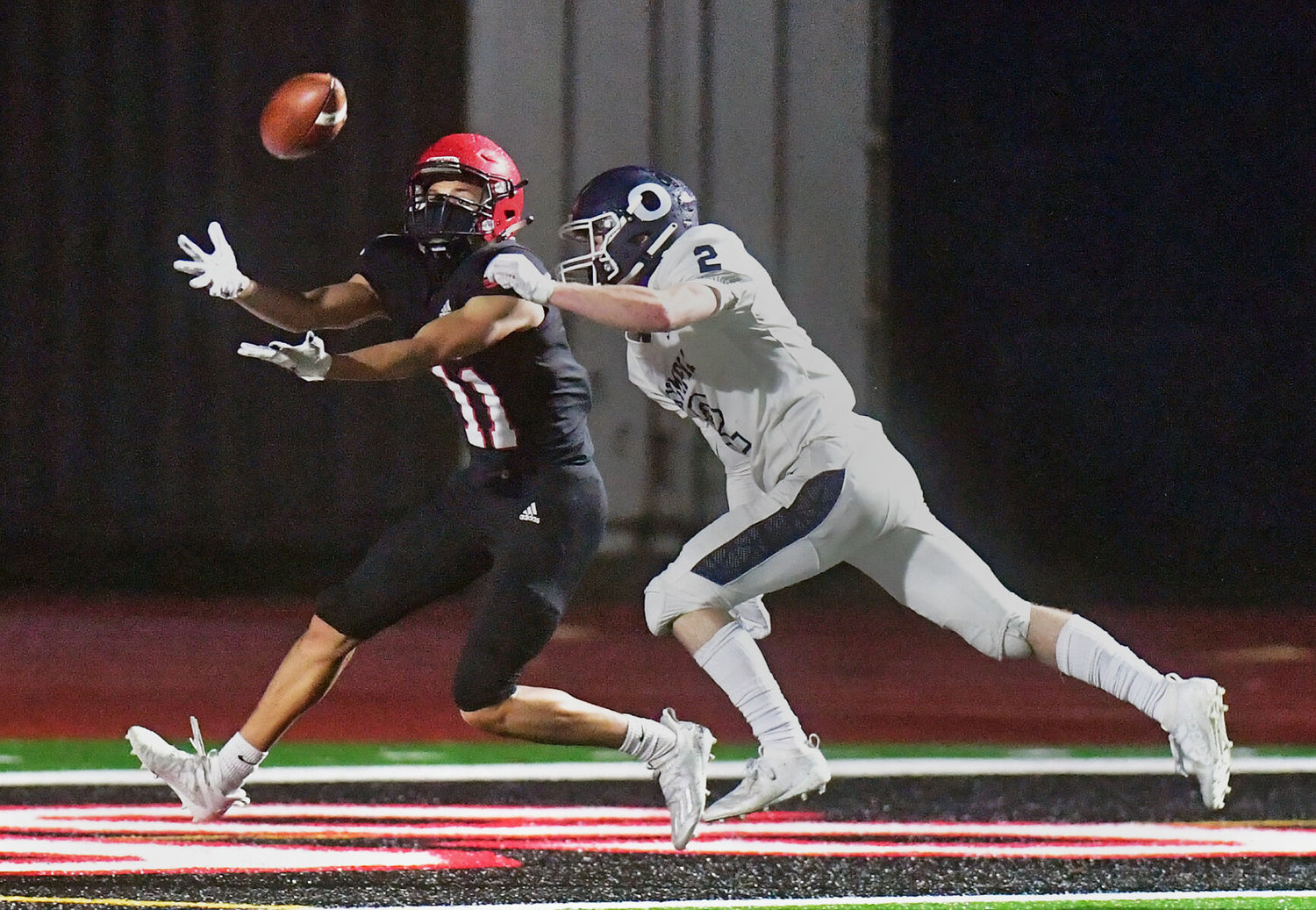 Yelm High School wide receiver Terelle Dunn stretches for a pass in the end zone against an Olympia High School defender on Friday, Feb. 19, at the YHS stadium, but didn't quite make the catch.