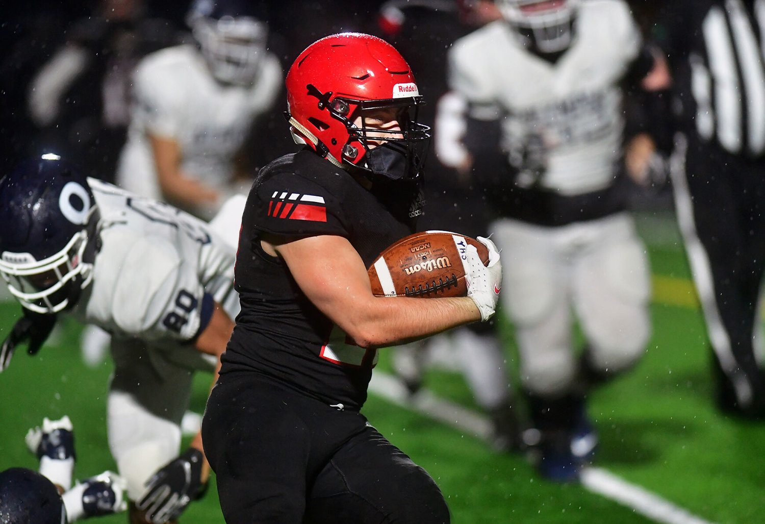 Yelm High School running back Sean Rohwedder busts loose for a big gain against Olympia High School on Friday, Feb. 19 as the Tornadoes began their shortened season by whipping the Bears 31-7 at the YHS stadium.
