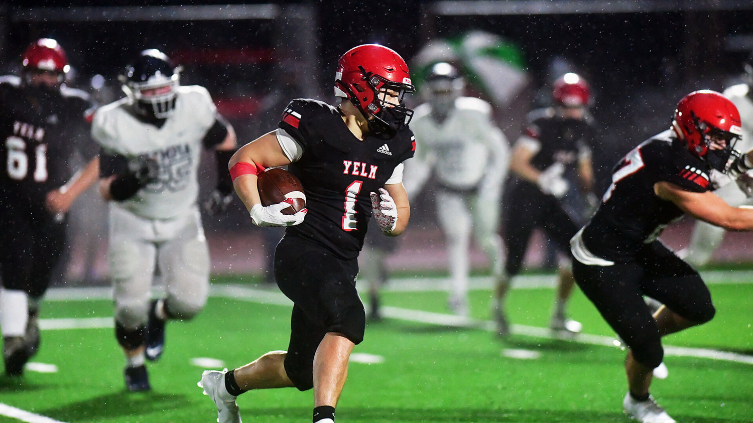 Yelm High School running back Ray Wright sprints for good yardage against Olympia High School on Friday, Feb. 19, at the YHS stadium.