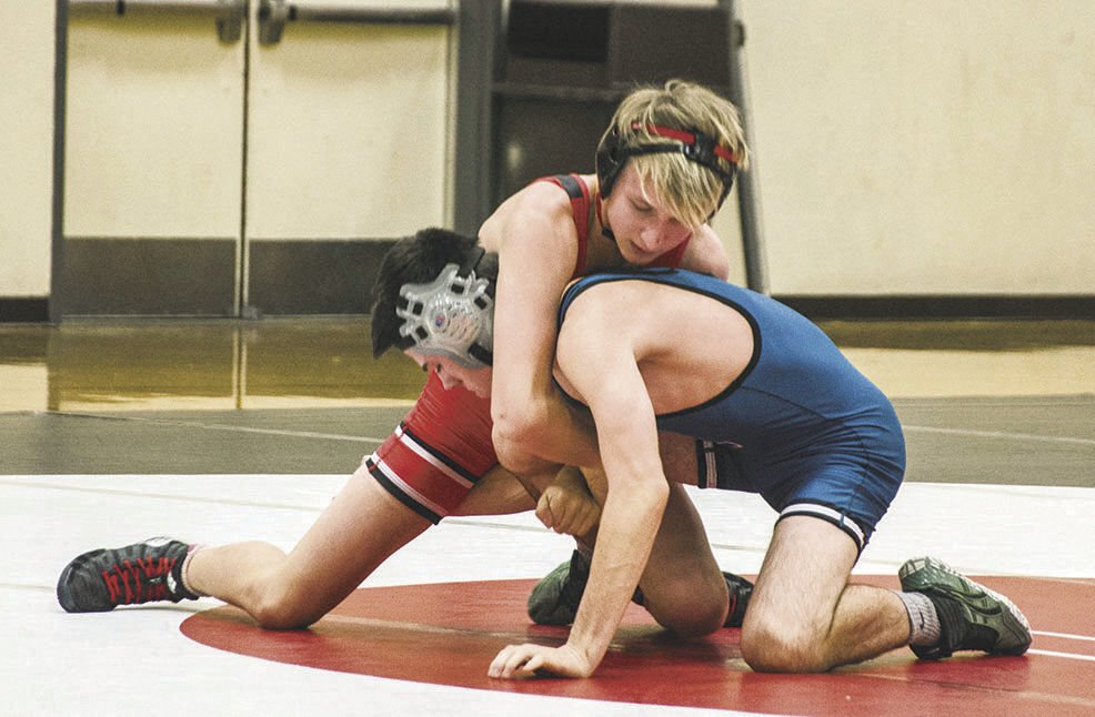 Gage Nelson (120) puts his Spanaway-Lake opponent in a hold.