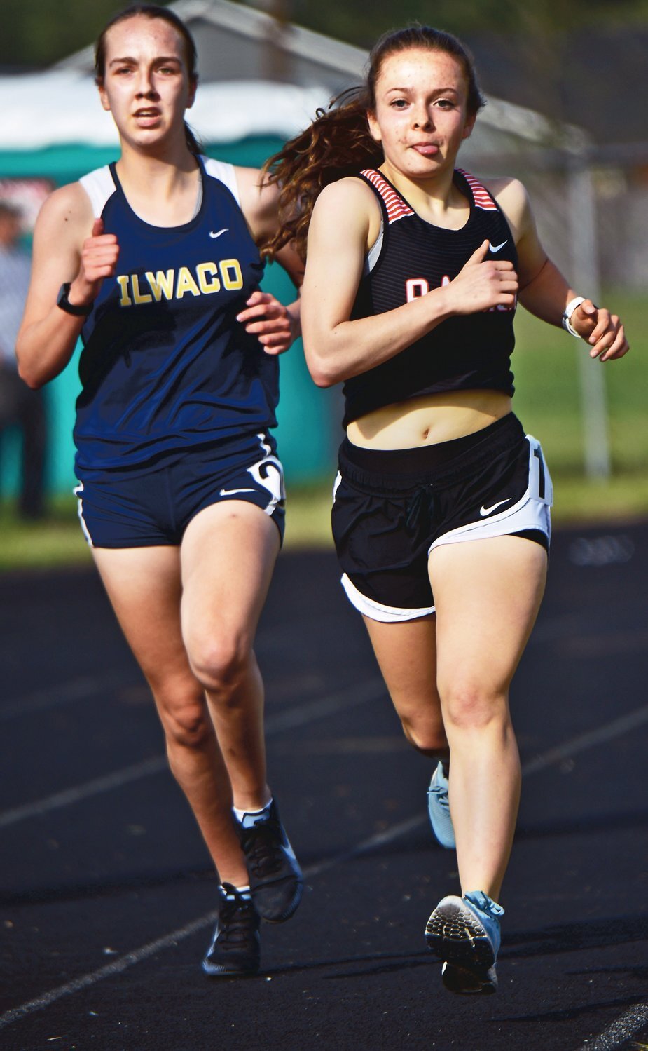Rainier High School’s Selena Niemi, right, goes on to win the 1,600-meter run on Thursday, April 29, during the WIAA 2B District 4 Track & Field Championships at Rainier High School.
