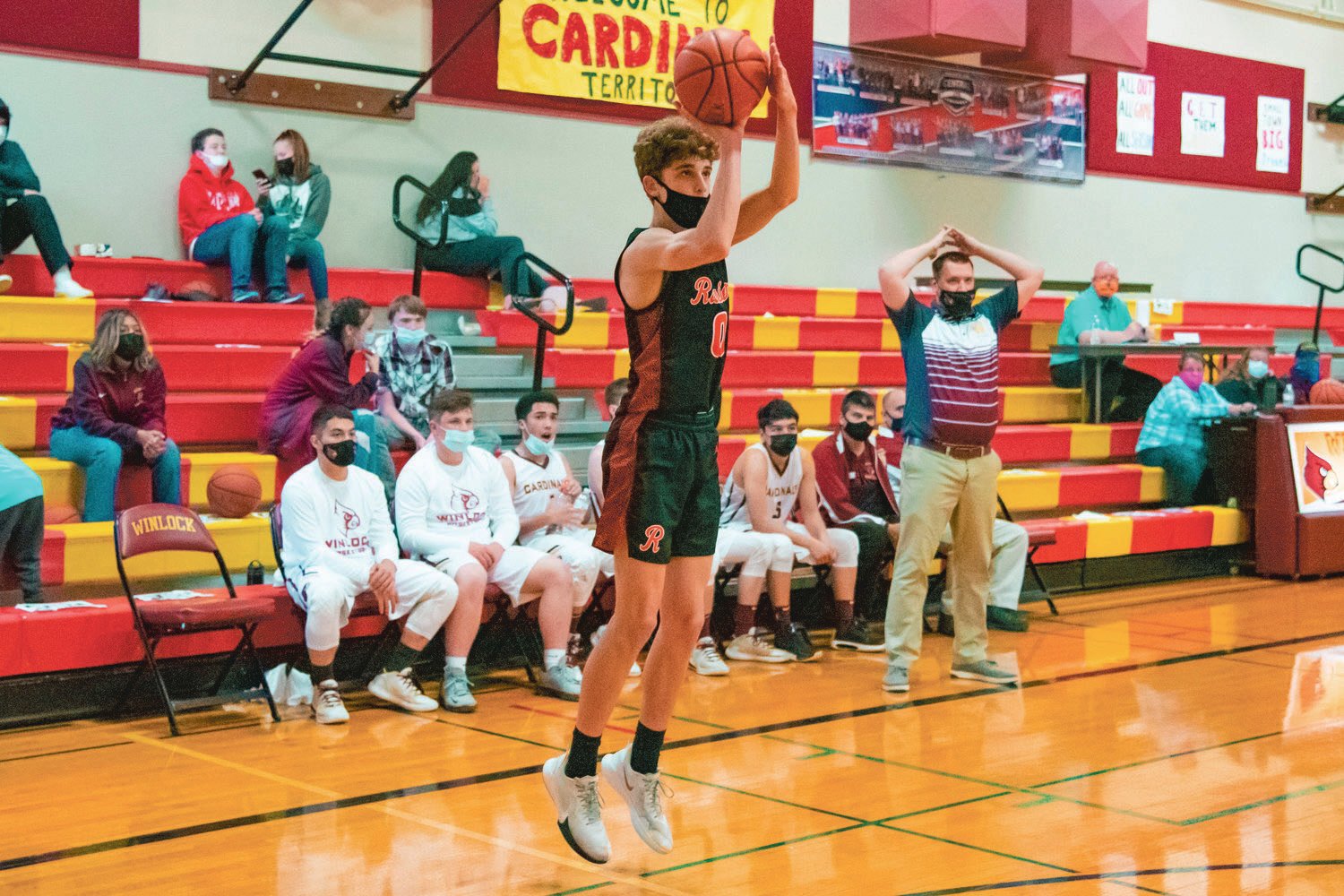 Rainier’s Ian Sprouffske (0) makes a three-point shot during a game against the Cardinals in Winlock.