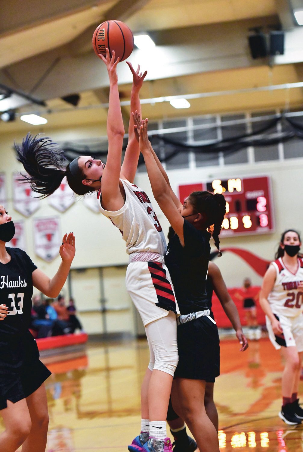 Bayleigh Harder, Yelm High School varsity girls basketball center, left, soars for a shot in the Tornados’ game Thursday, May 27, against River Ridge High School.