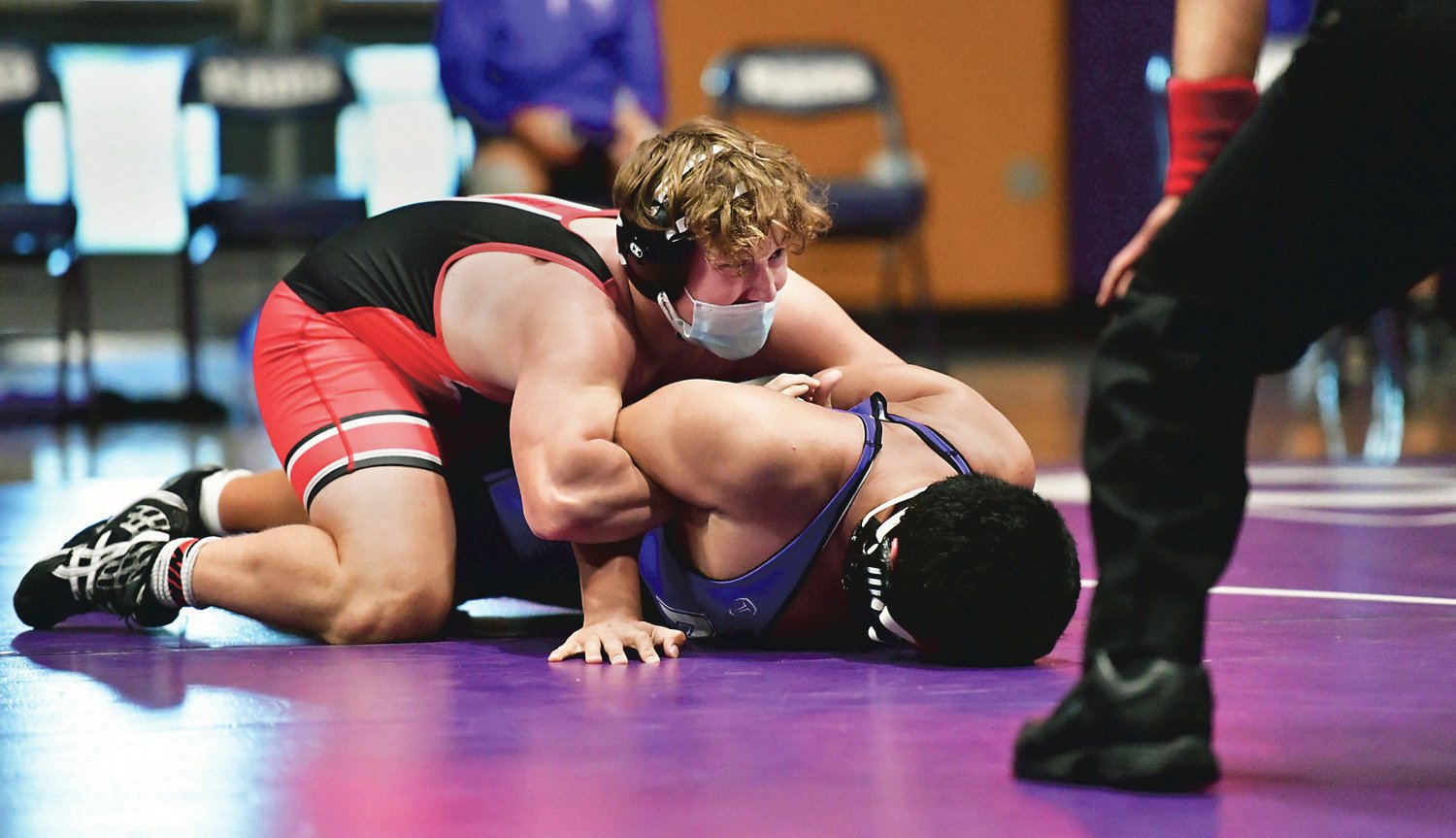 Yelm High School wrestler Cael Gendron, on top — a junior — wrenches down his North Thurston High School opponent on Wednesday, May 12, to win his match by pin.