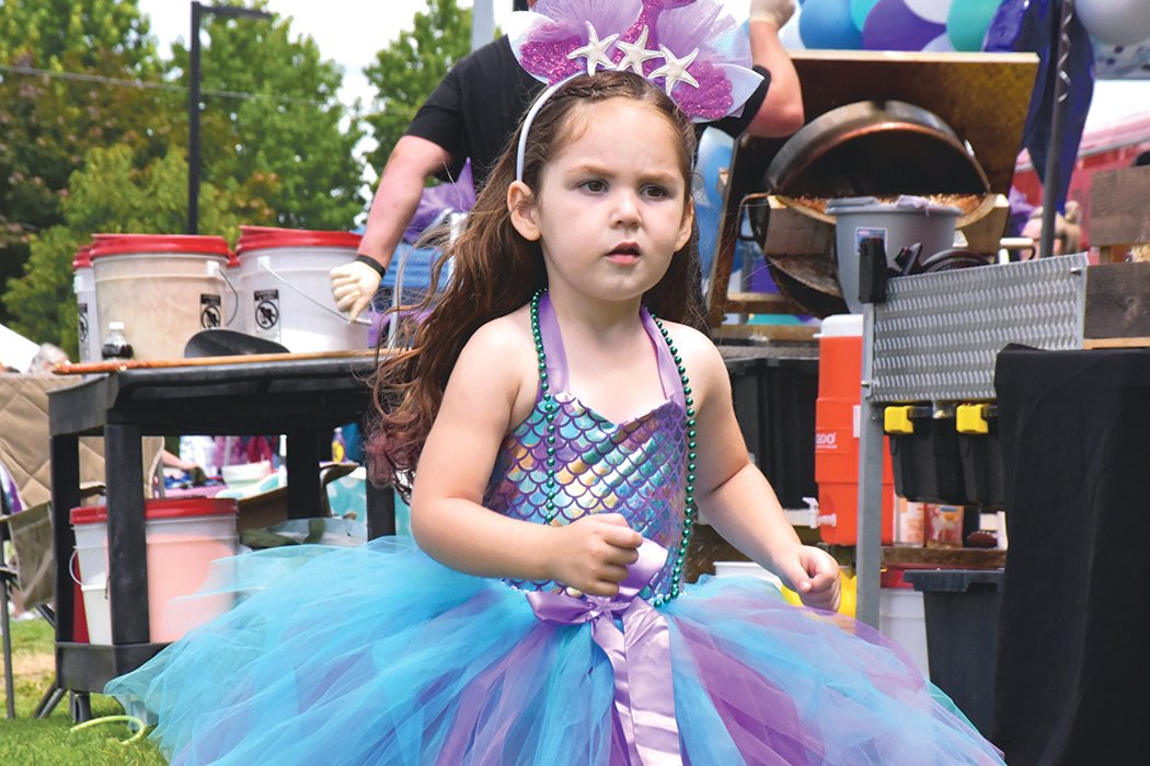 A mermaid, who graciously accepted the invite to the 2021 Yelm Mermaid Festival, struts around Yelm City Park on a mission to have a great time on Saturday, July 17.