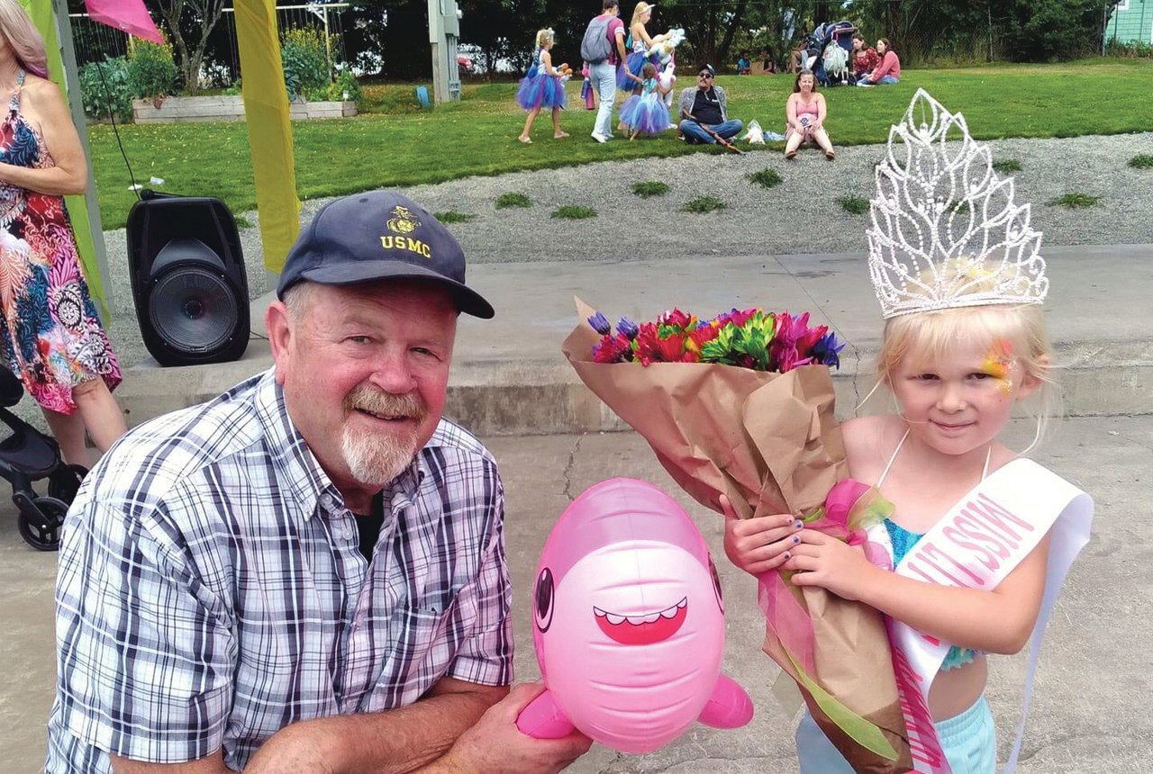 The 2021 Kids Mermaid Fest Queen Keegan Mcmenamy of Rainier shows off her crown with Yelm Mayor JW Foster in the Yelm Mermaid Festival.