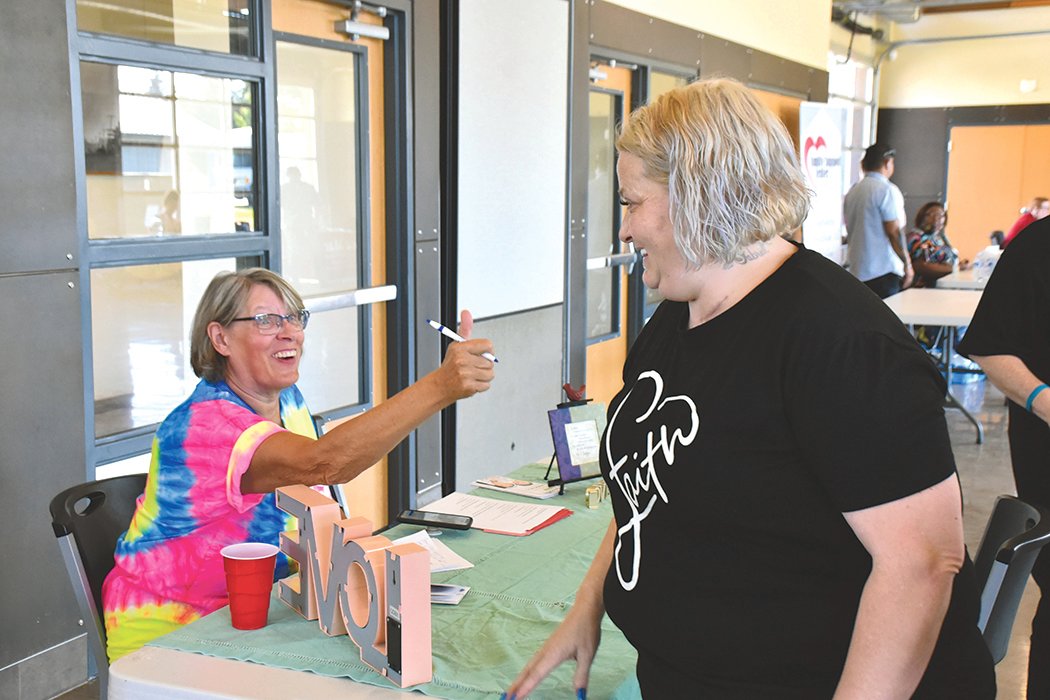 Yelm resident Sherry Short, right, systematically goes from booth to booth to gain information about how she can best handle a switch up in her housing situation at the July 29 Community Resource Fair at the Yelm Community Center.