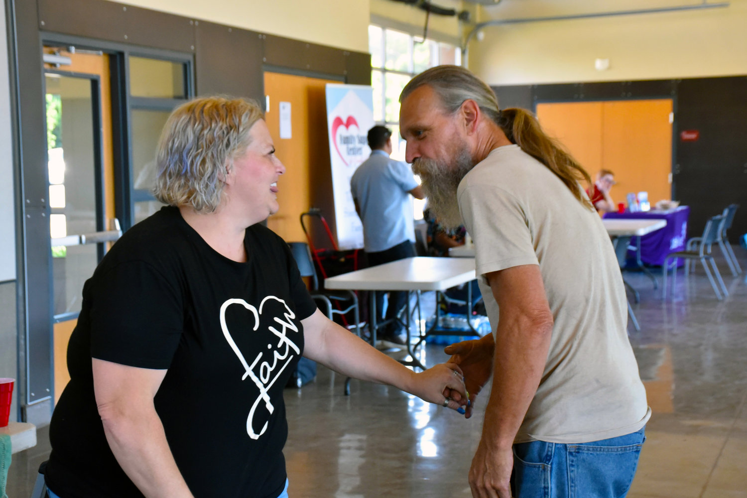 Yelm resident Sherry Short greets a friends at the Yelm Community Resource Fair on July 29 at the Yelm Community Center.