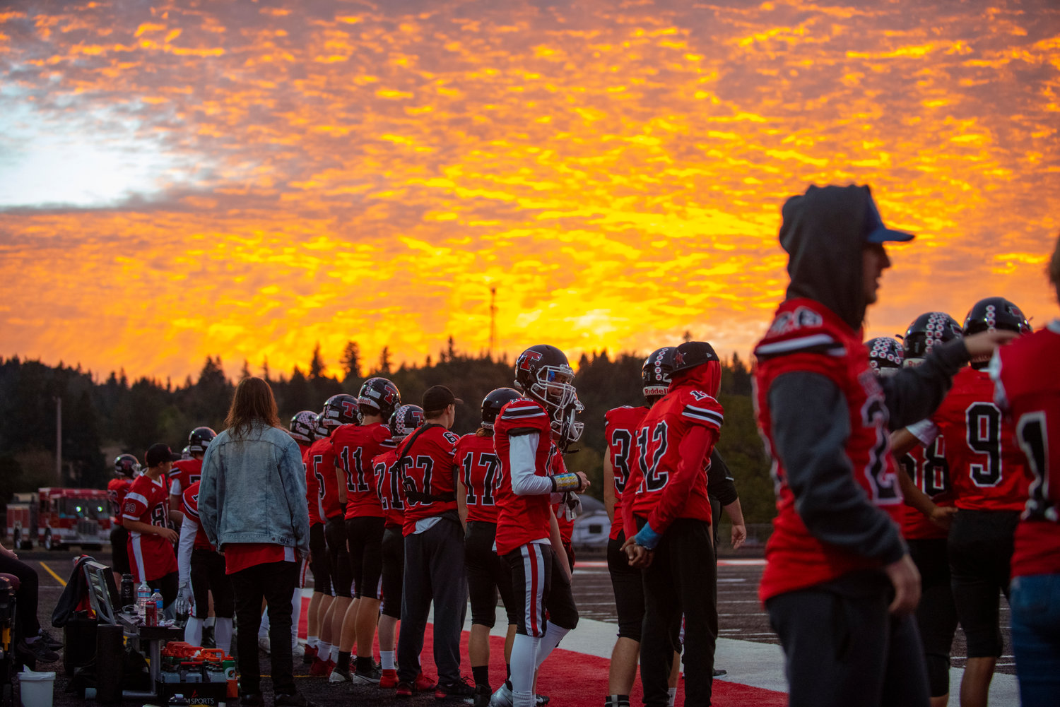 The sun sets during the first quarter of Tenino's home football game against Onalaska on Friday.