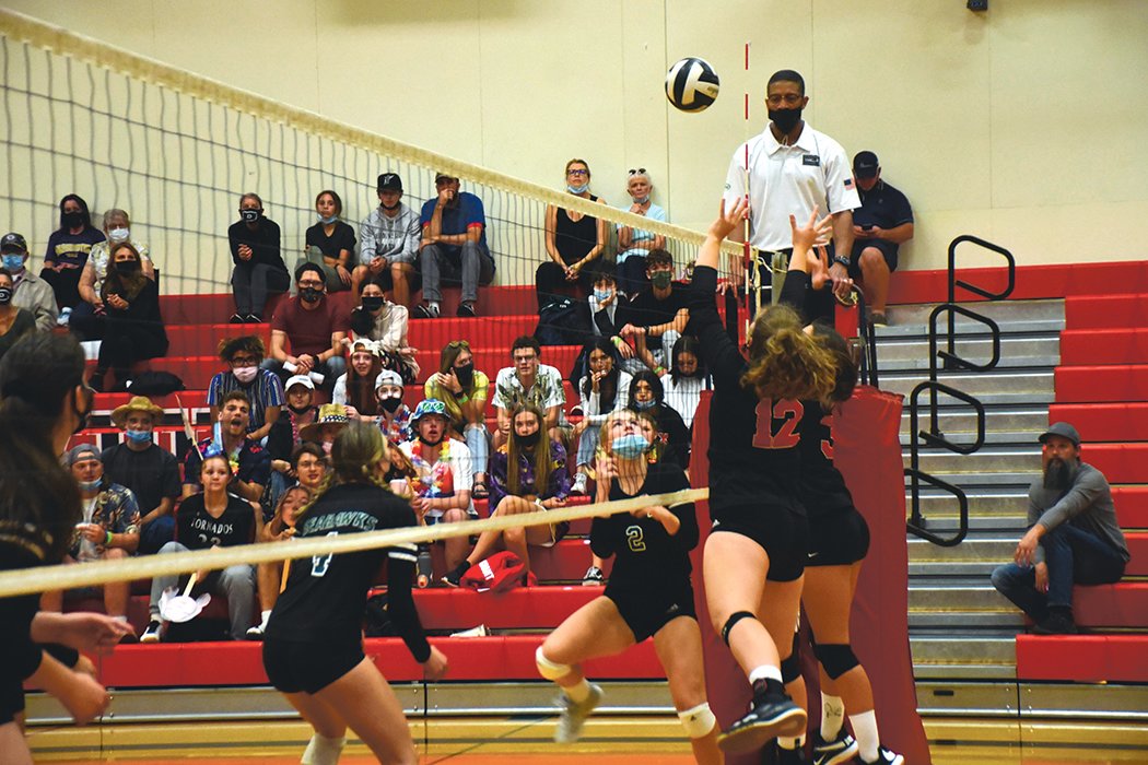 Mya Phelps (#12) and Selina Perez (#11) defend against Peninsula High School at the volleyball match on Thursday, Sept. 23 at Yelm High School.