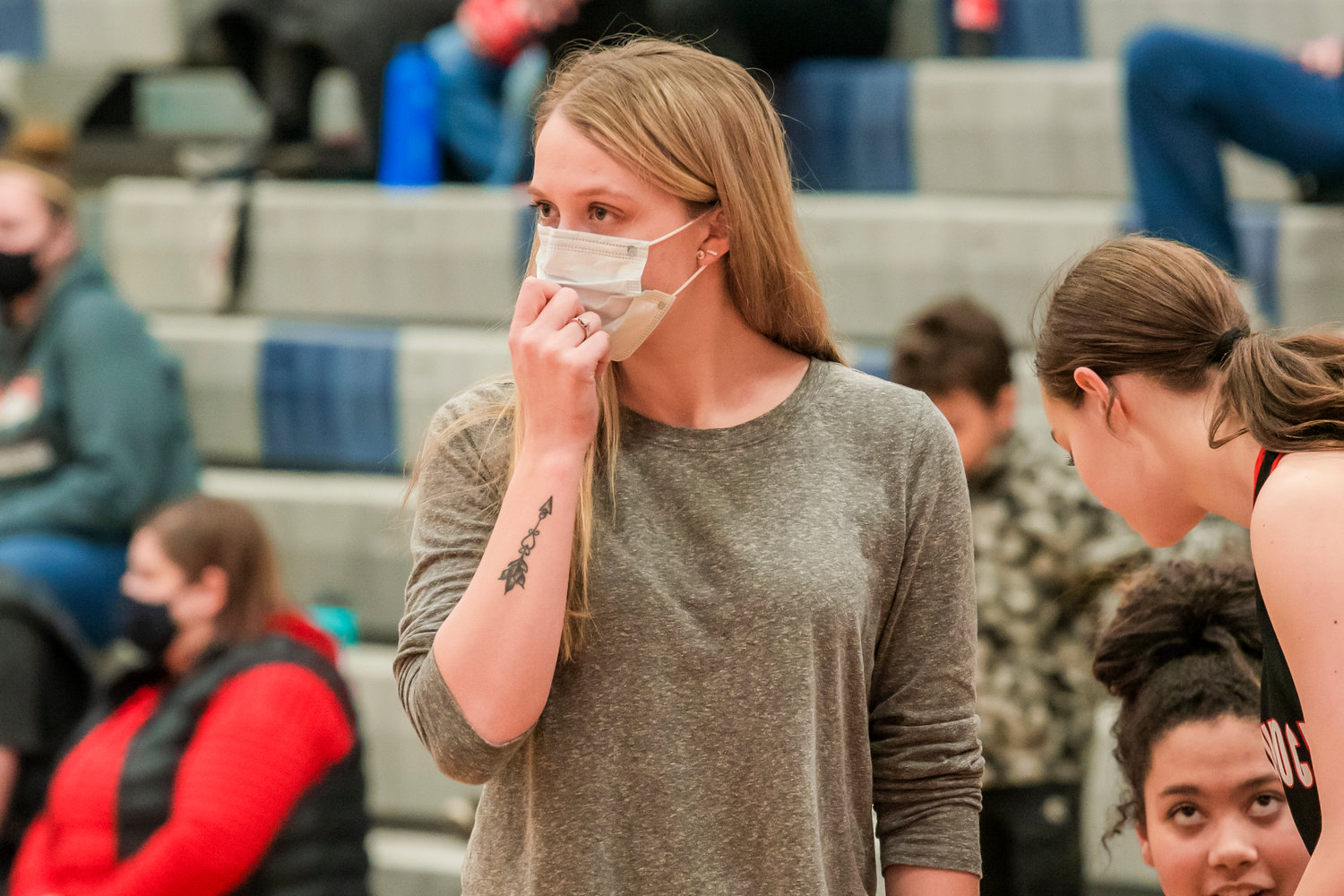 Mossyrock Head Coach Autumn Moorcroft adjusts her mask while talking to athletes on the court in Rainer Thursday night.