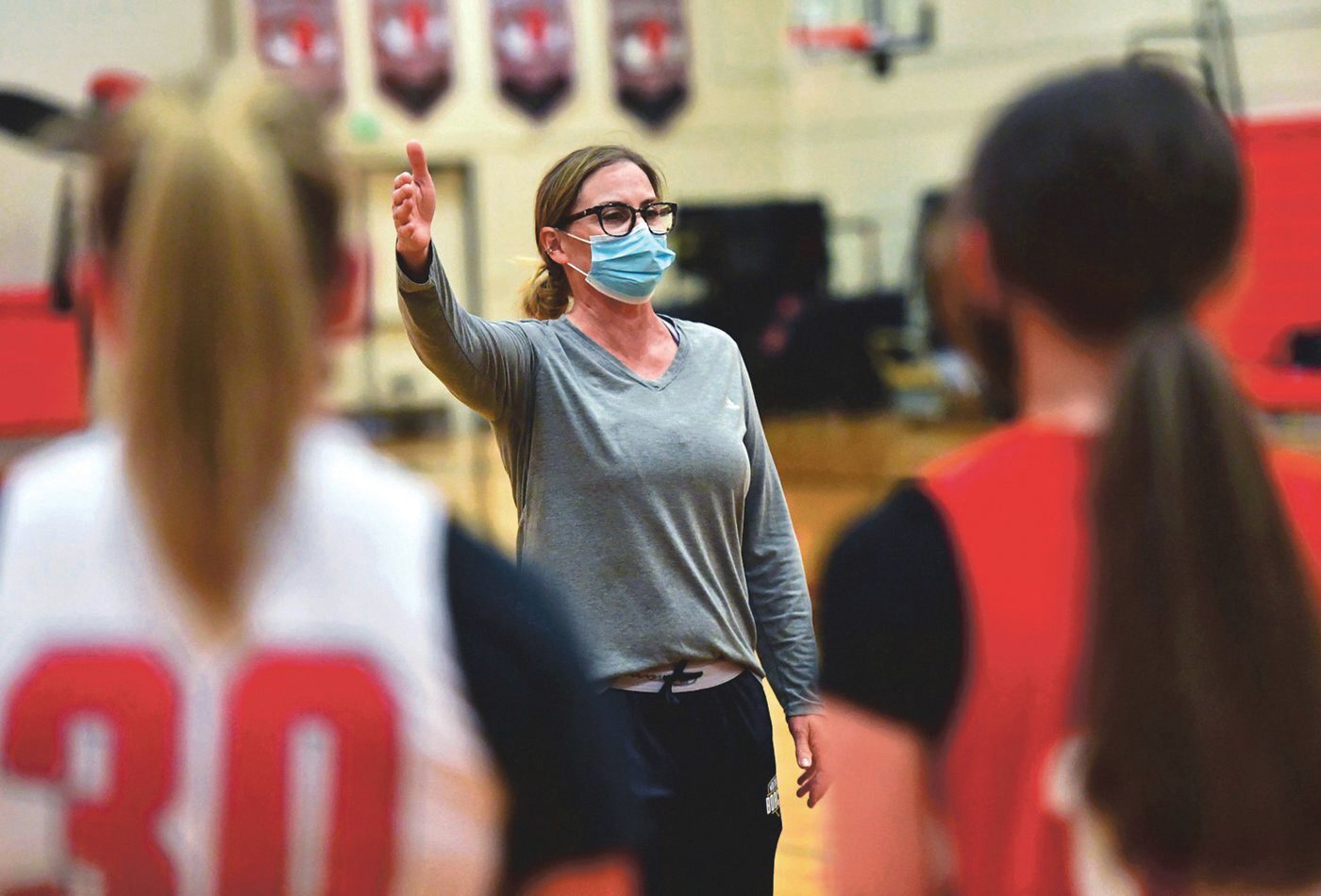 Jennifer Sleeman, Yelm High School girls basketball coach, instructs her team during practice on Monday, May 3, in the Yelm gym.