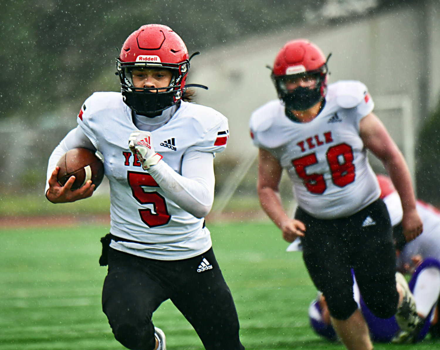 Yelm High School quarterback Kyler Ronquillo scampers for one of his many ground gains against North Thurston High School Friday, March 19, 2021 at South Sound Stadium.