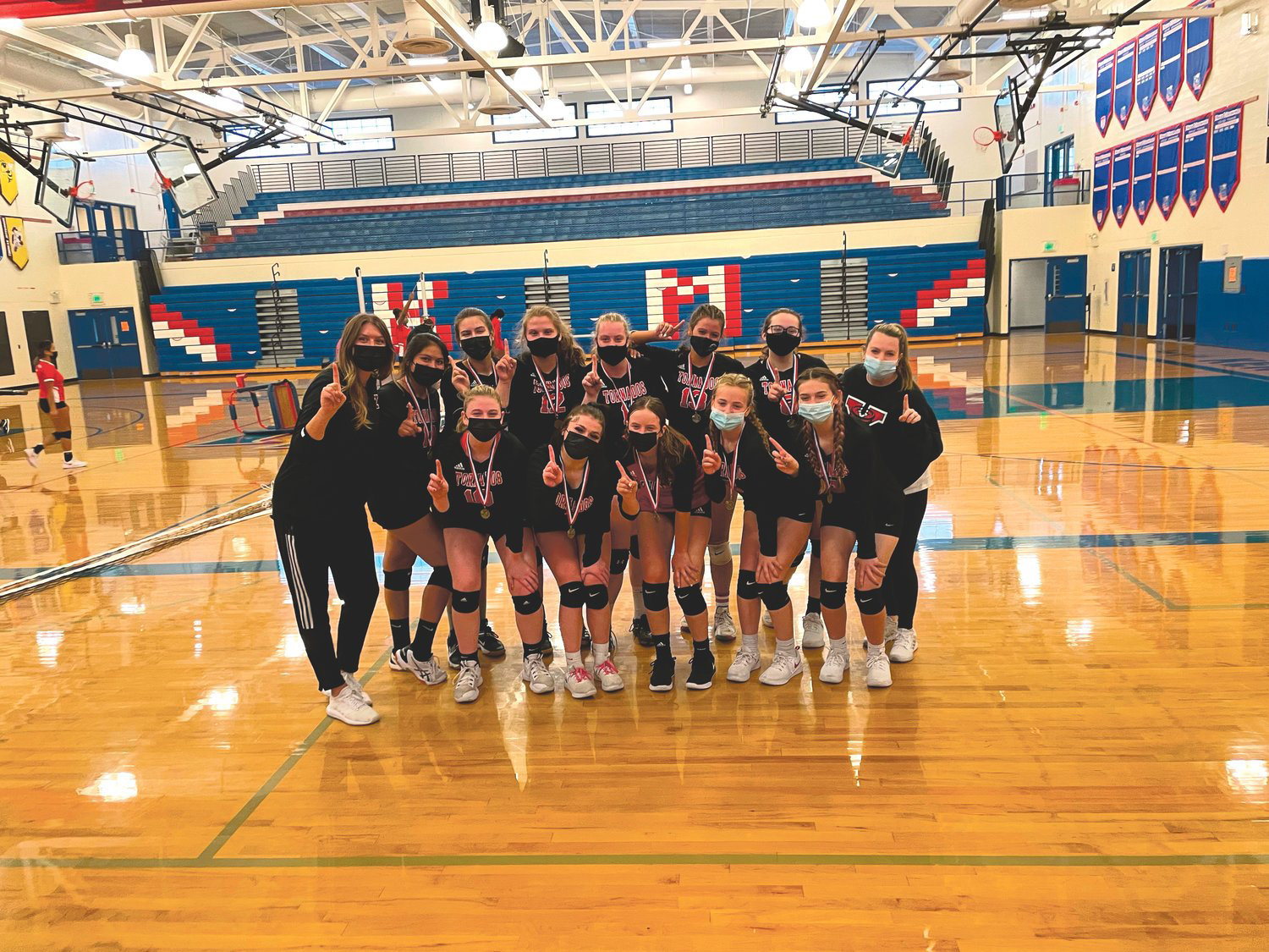 The fall 2021 Yelm High School Volleyball team celebrates after a tournament win.