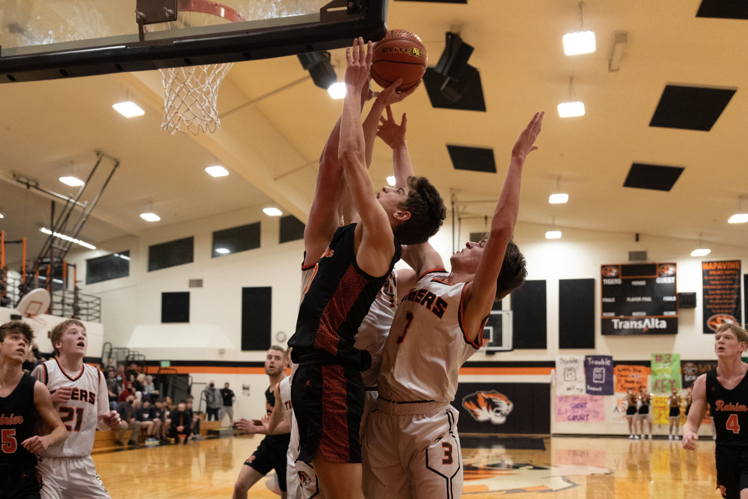 Rainier guard Ian Sprouffske is bracketed by Napavine defenders while driving for a layup Jan. 4.