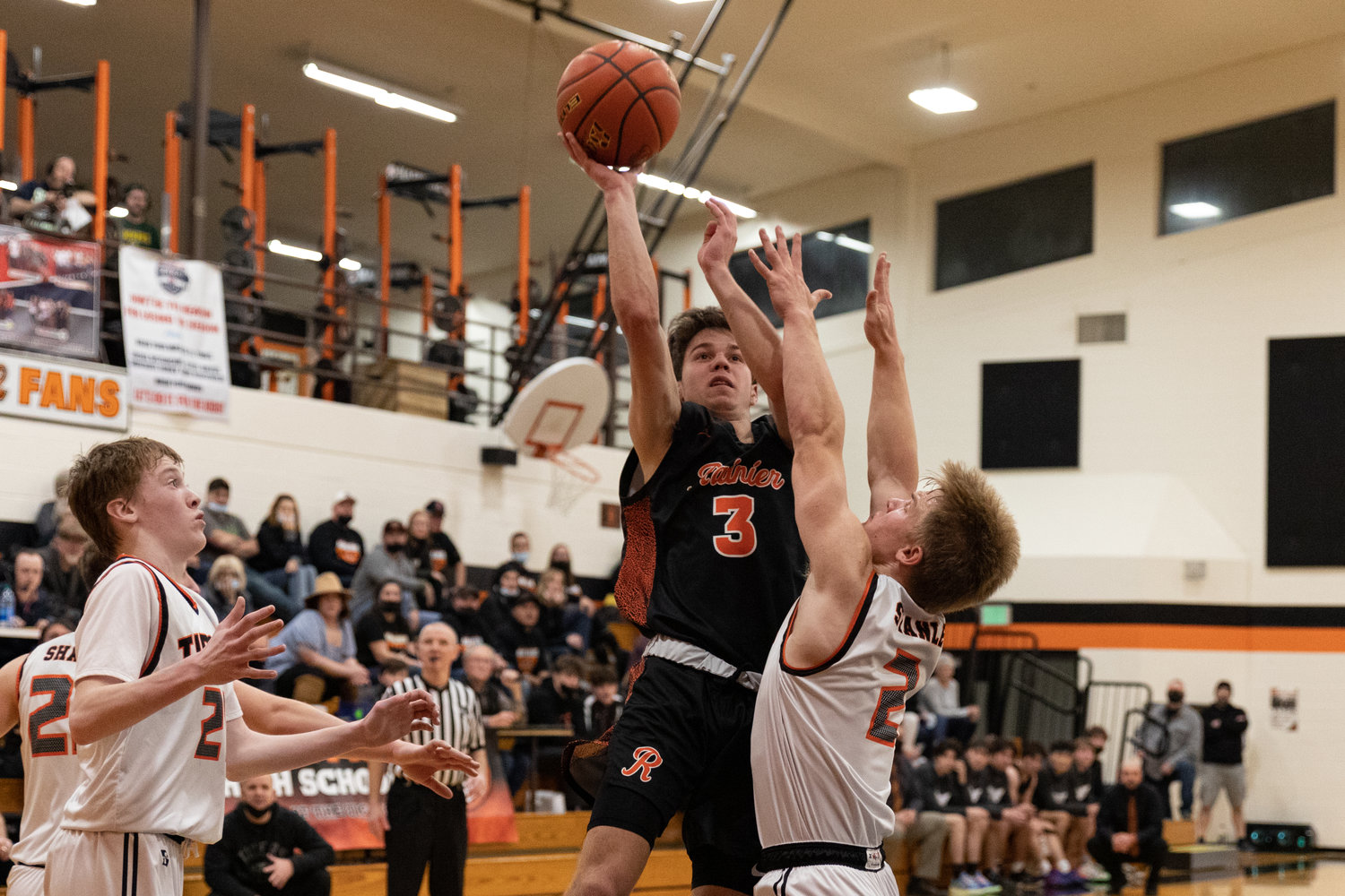 A Rainier guard throws up a floater against Cael Stanley and Napavine Jan. 4.