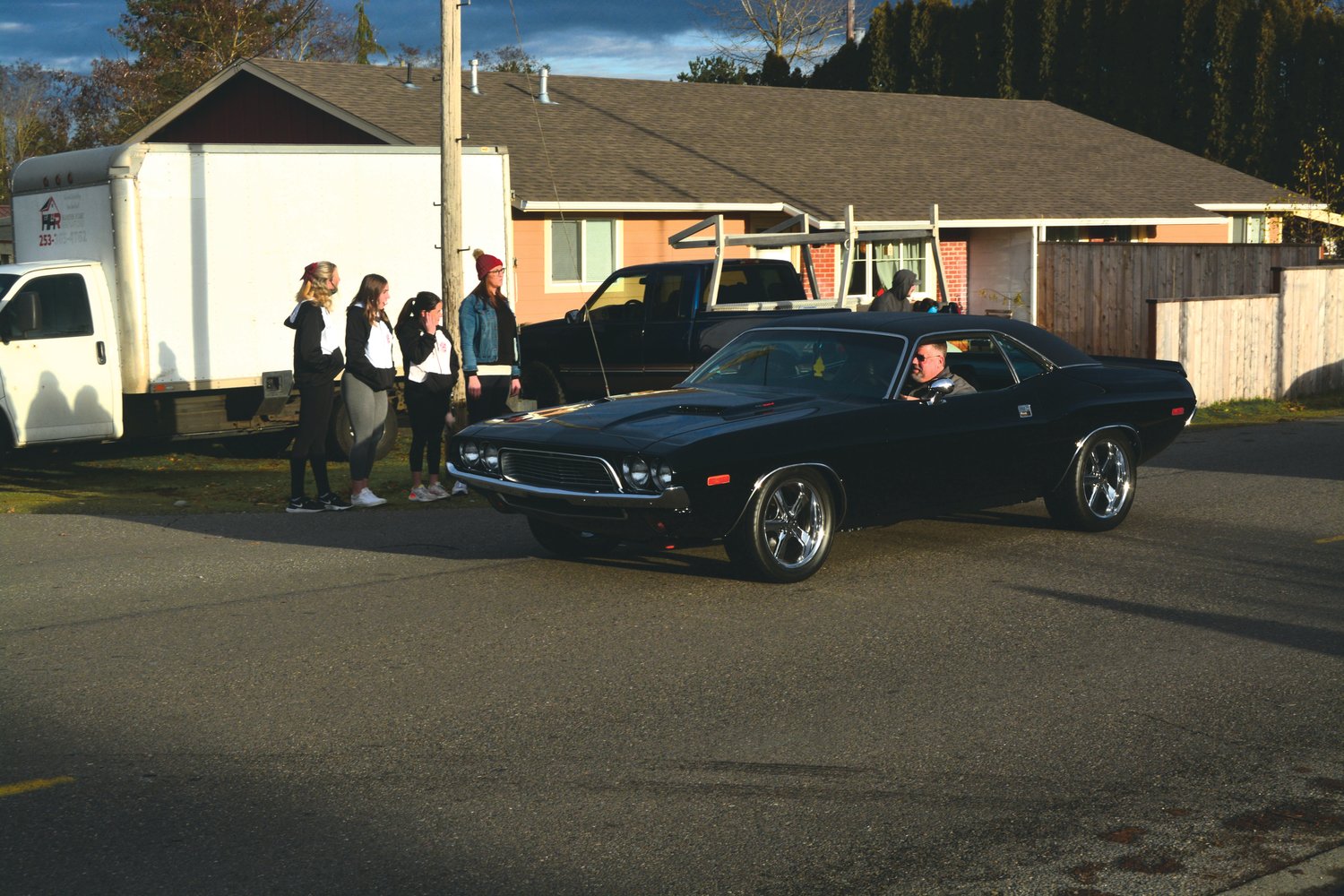 A man drives his car outside of Jeren Pollock’s home on Jan. 8 during a car parade.