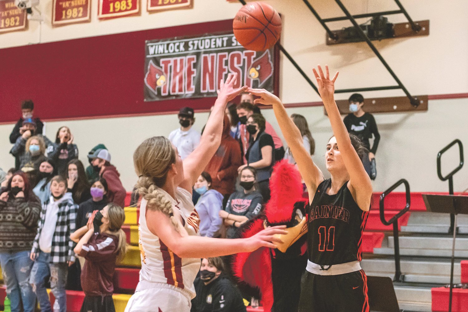 Rainier’s Faith Boesch (11) puts up a three-point shot during a game in Winlock Wednesday night.
