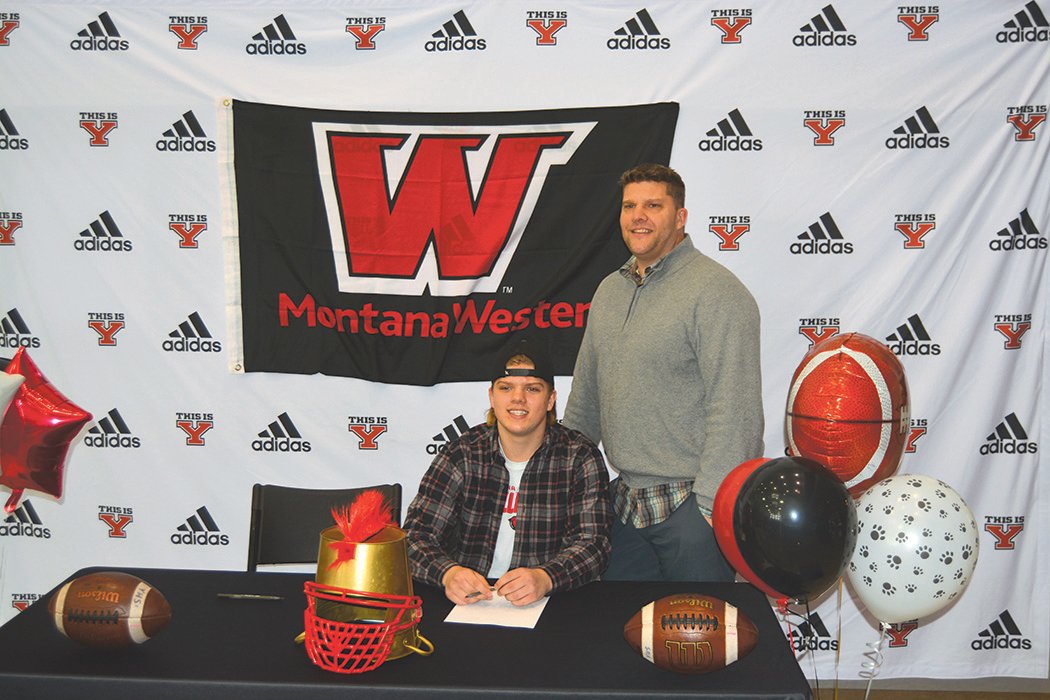 Cooper Cleveringa is pictured with his father at a signing event on Feb. 2. Cleveringa singed a letter of intent to play football at the University of Montana Western in Dillon, Montana.
