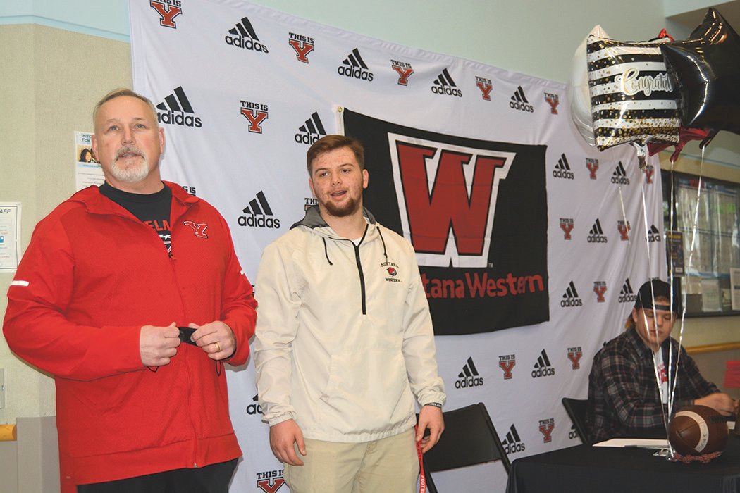 Offensive Line Coach Brian Foote stands with Kollin Gifford during a signing ceremony at Yelm High School on Feb. 2.
