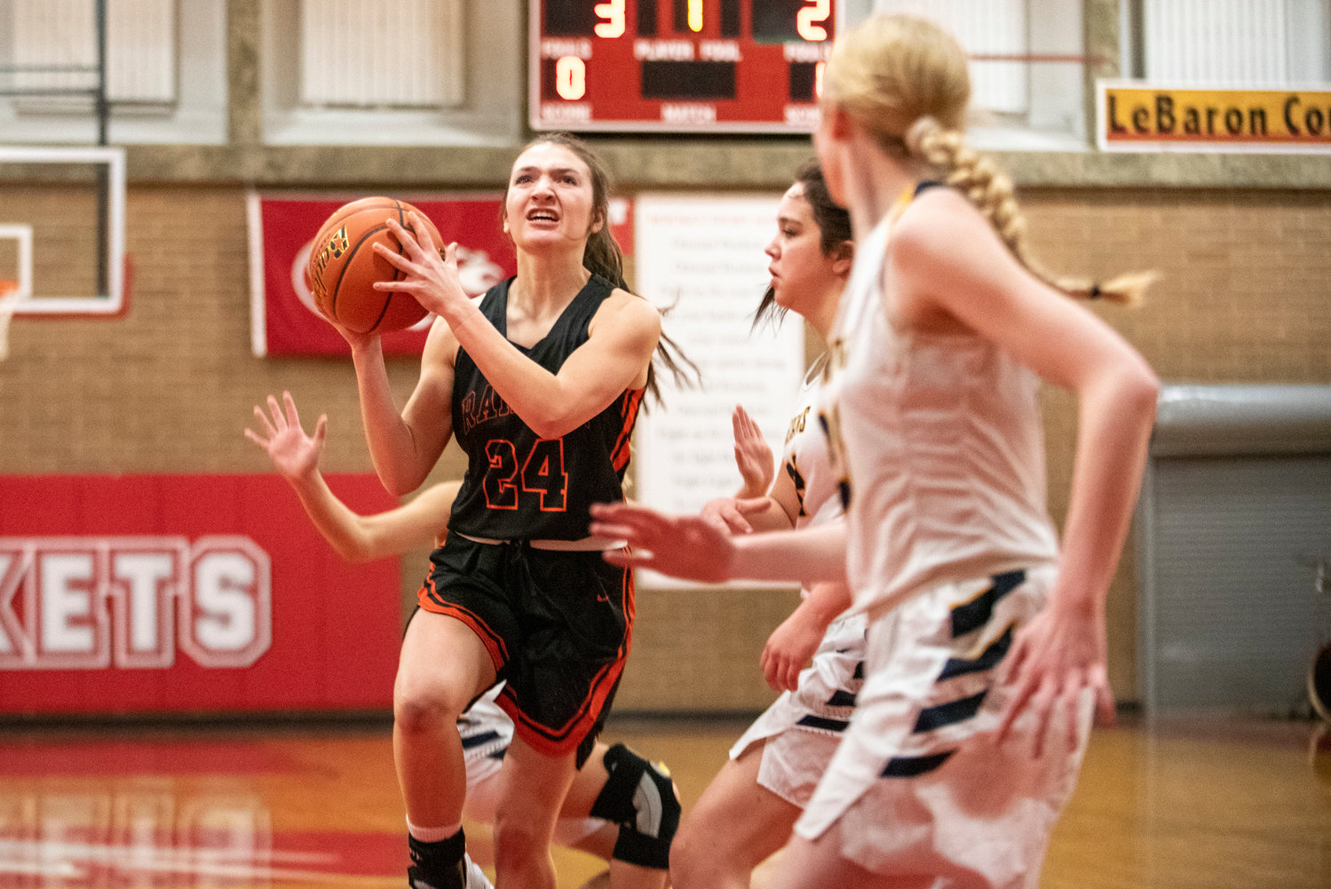 Rainier's Bryn Beckman (24) drives to the bucket against Forks on Feb. 15.