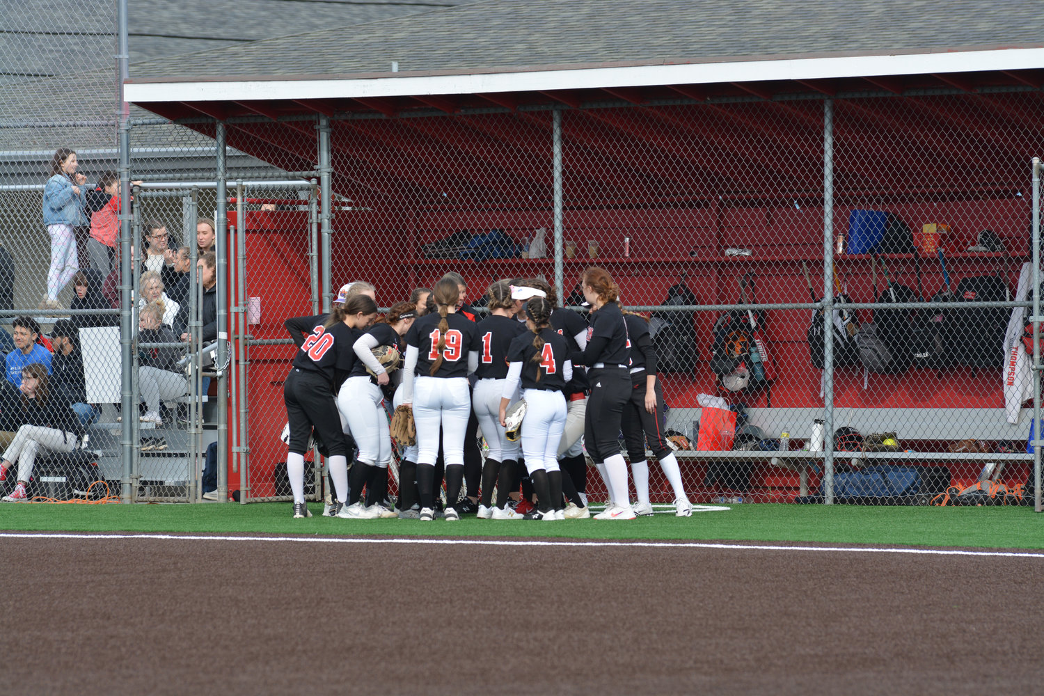 The Yelm fastpitch team huddles mid-inning.
