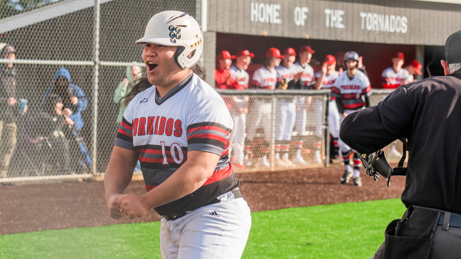 Yelm’s Kolby Henry (10) celebrates after sliding in safe at home during a game against Timberline High School on Tuesday, March 15.