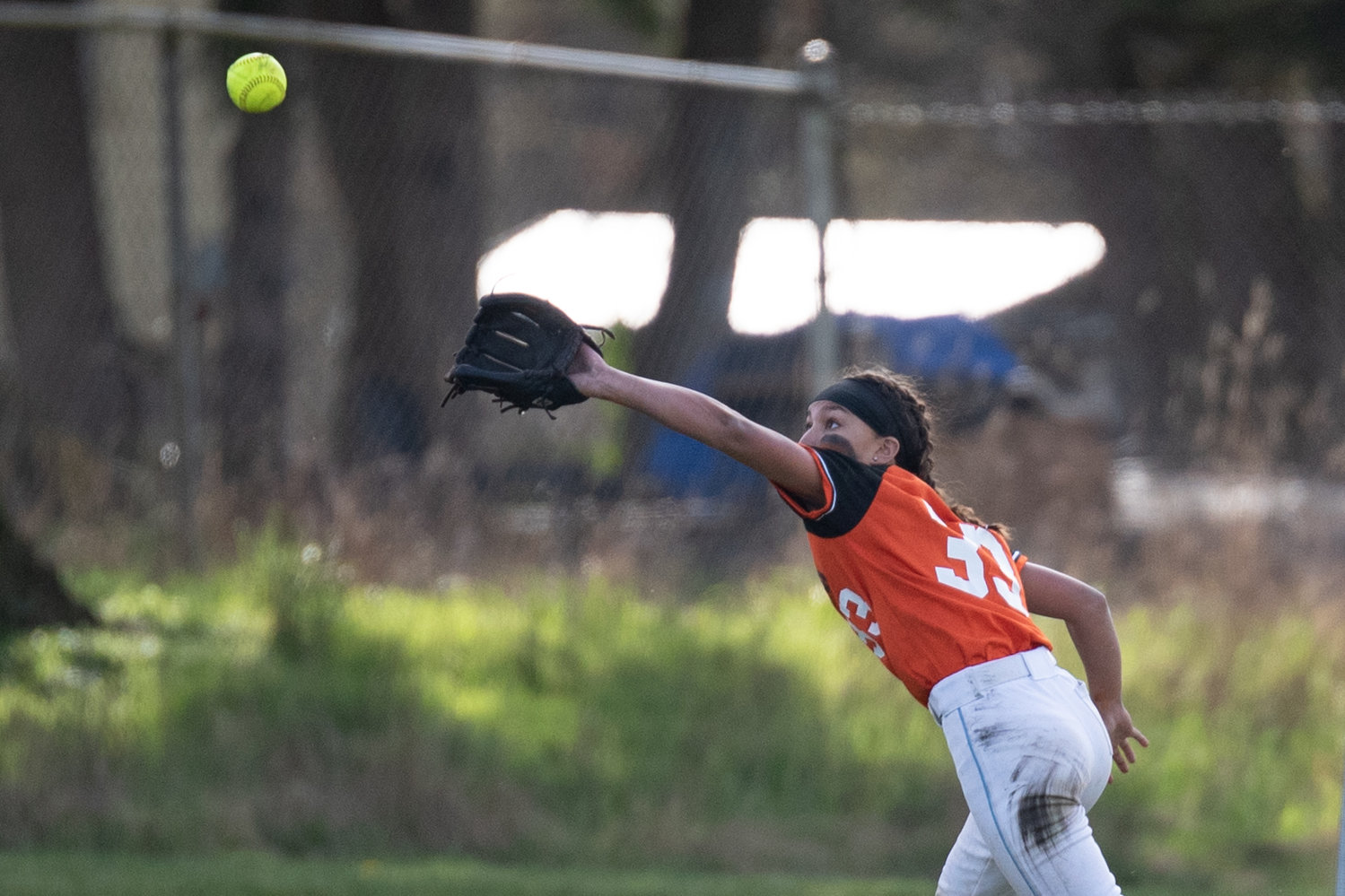 Rainier left fielder Madison Mounts stretches for an out against Tenino March 24.