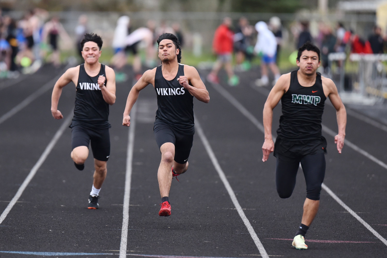 Mossyrock's Christian Paz Tapia, middle, and Morton-White Pass' David Martinez, right, race in the boys 100-meter dash in Tenino on March 29.