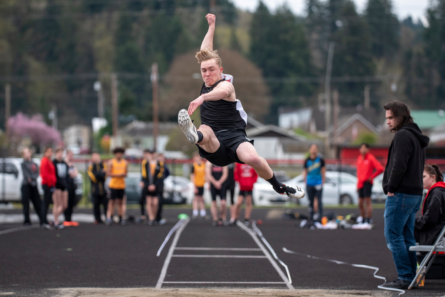 Tenino's Gavin Watson catches air in the boys long jump during a home meet on March 29.