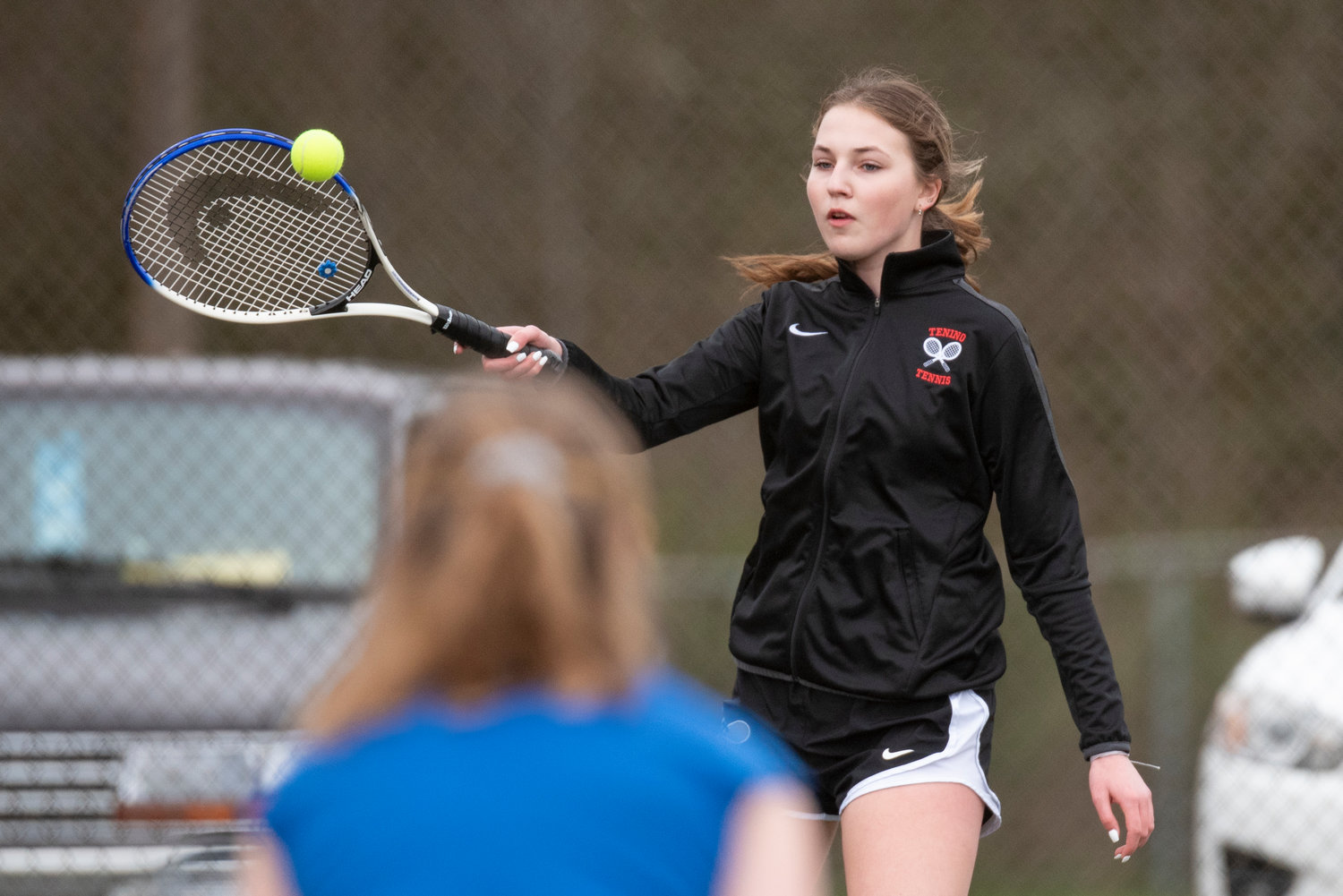 Tenino's Rilee Jones returns a serve from an Eatonville player in No. 1 doubles during a home meet on March 29.