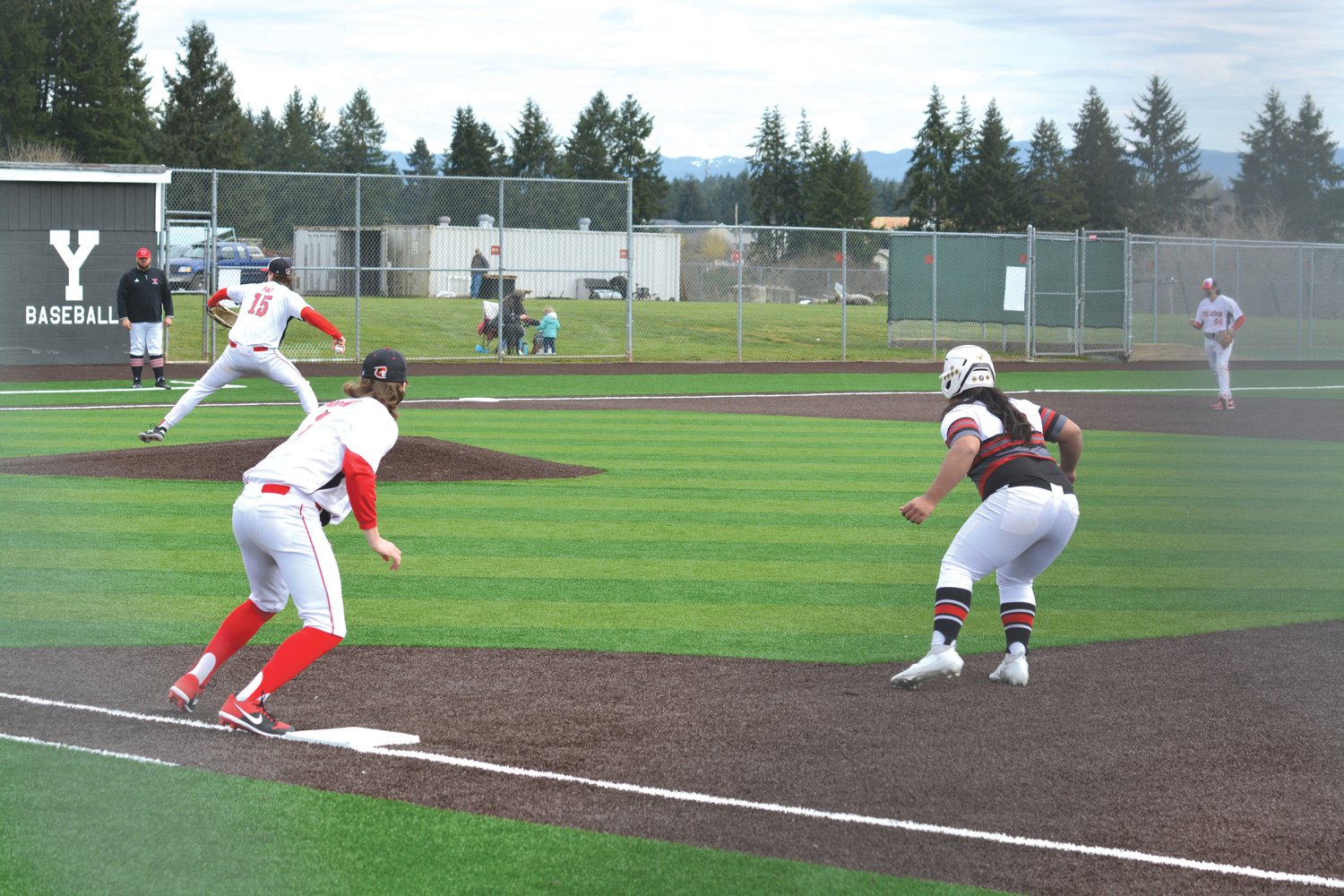 Junior third baseman Kolby Henry takes a lead on first while the pitch is delivered during a game against Steilacoom High School on April 1.