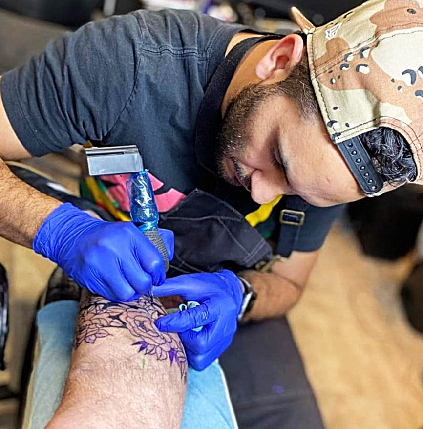 Cesar Cortez works on a piece at Dancing Needles Tattoo Studio in Yelm.