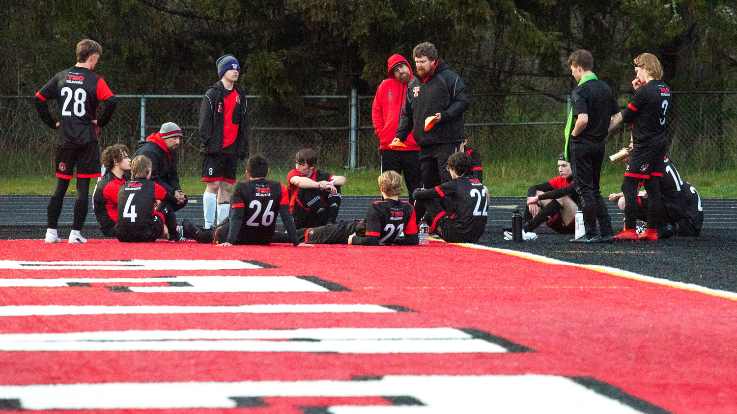 Tenino Head Coach Kevin Schultz talks to players on the sideline  Wednesday evening during a game.