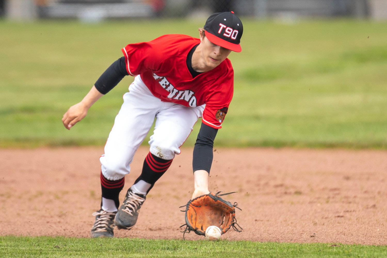 Tenino second baseman Cody Strawn fields an Elma grounder during a home game on April 29..