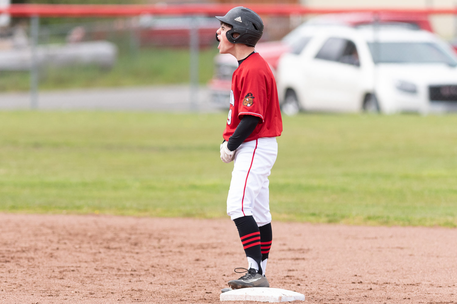 Tenino's Will Feltus yells in celebration toward his dugout after hitting a double against Montesano May 3.