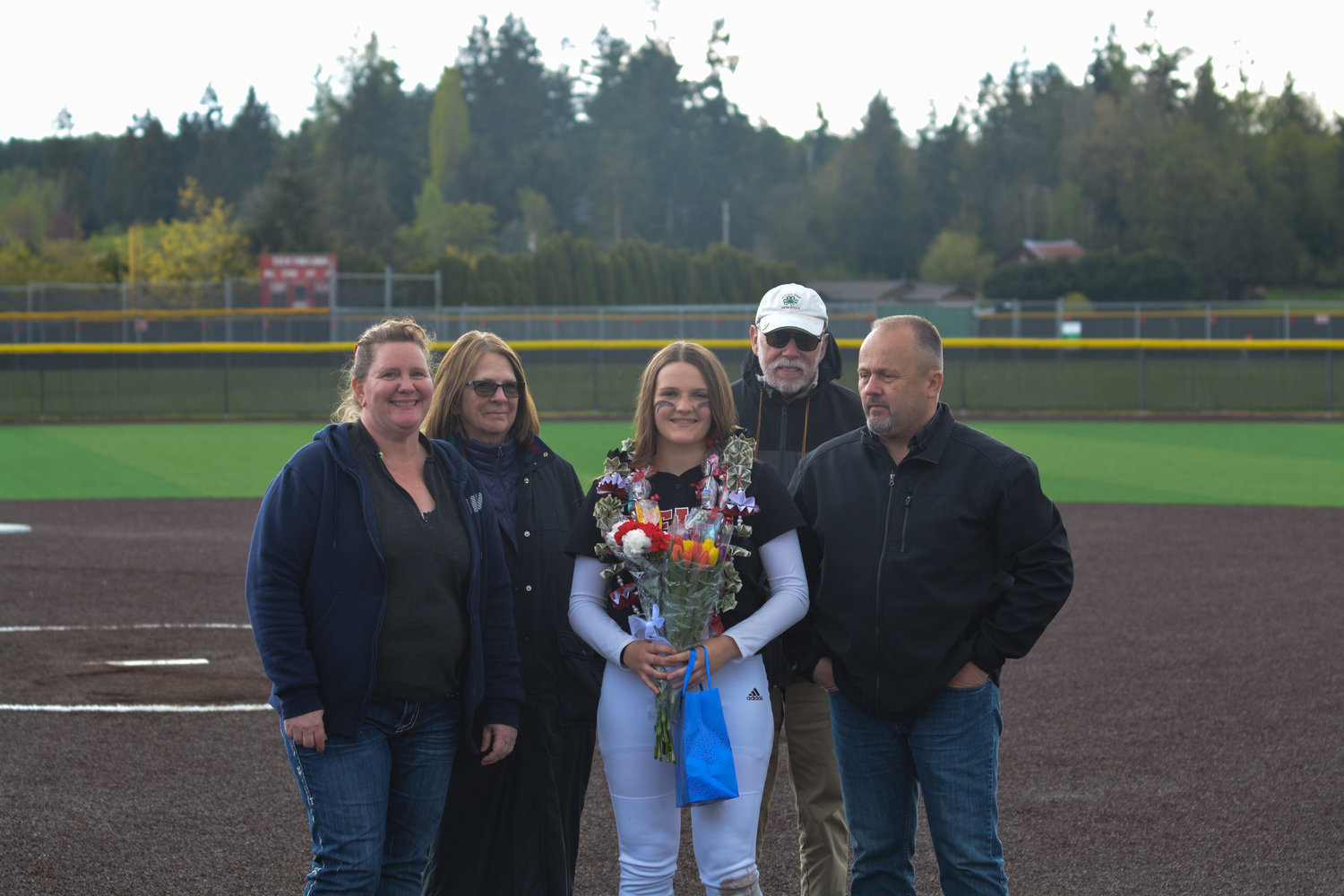 Senior outfielder Katelyn Cederburg poses with her family after the senior night game on May 9.