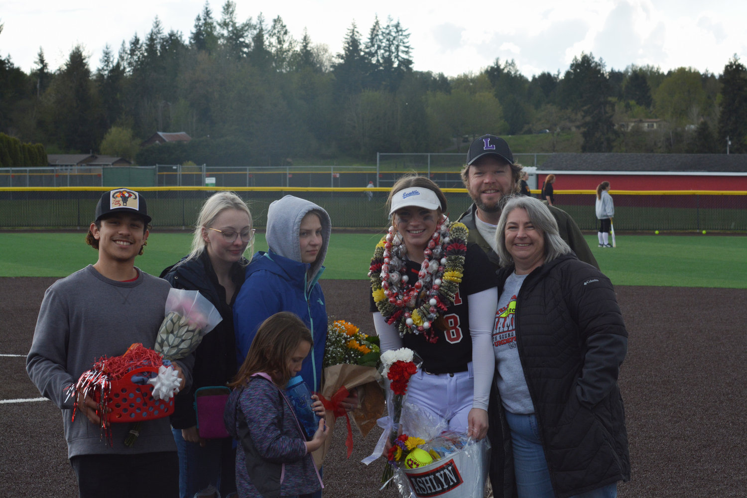 Senior third baseman Ashlyn Aven poses for a photo with her family and boyfriend after the senior night game on May 9.
