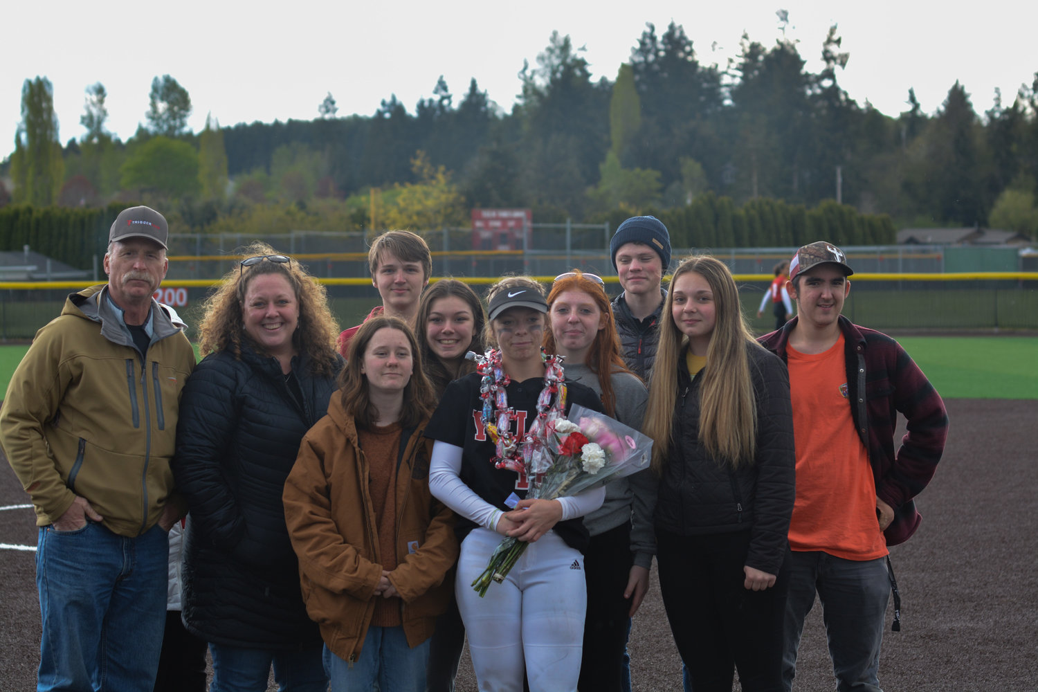 Senior catcher/utility Kendall Lawson poses for a photo with her family following the senior night contest on May 9.