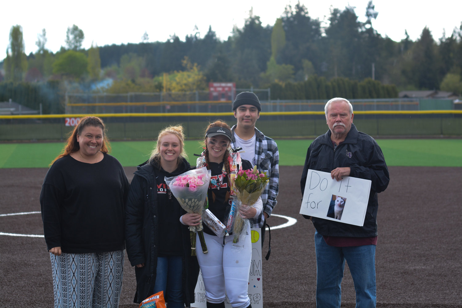 Senior pitcher Vivian Watts poses with her family following the Senior Night outing on May 9.
